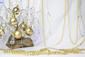 Christmas background with a Christmas tree on which small golden balls hang. Selective focus, a picture for the background. the concept of Christmas and New Year. photo