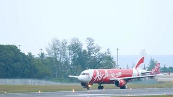 PHUKET, THAILAND NOVEMBER 26, 2017 - Airbus A320 of AirAsia taxiing after landing at Phuket airport. Tourism and travel concept video