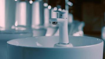 Rotating washbasin. Studio filming. In the background a row of toilets. 4k video