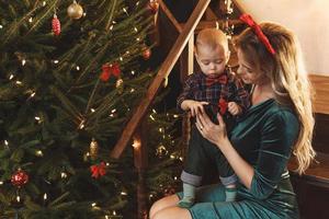 Happy mother and her cute little son are celebrating Christmas or New year. photo