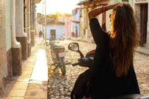 Woman scooter driver in the old city photo