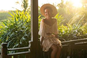 Beautiful woman on the summer terrace of her house photo