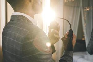 Man is using atomizer nozzle with perfume photo