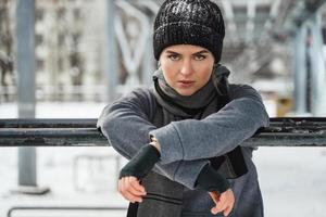 Young athletic woman during her winter workout outside photo