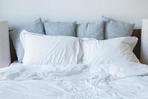 A lot of white pillows on the bed photo