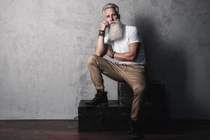 Handsome bearded senior man posing in studio photo