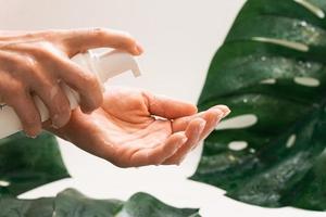 Woman is applying cleansing foam on her hand photo