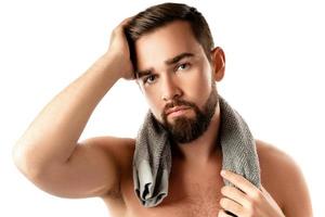 Young and handsome bearded man with smooth skin photo