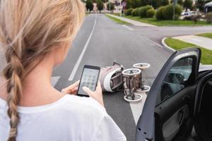 Driver makes 911 emergency call after a car accident with baby pram on the crosswalk photo