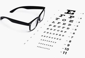 Eye chart for visual acuity testing and black rimmed eyeglasses photo