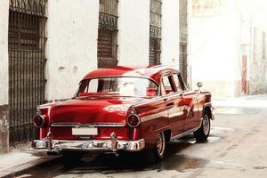 Shiny vintage red car parked on street photo