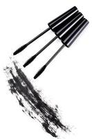 Brushes wands and smudged mascara on white background photo