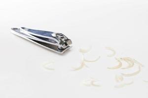 Clipper and dirty nails on white background photo