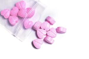 Ziplock bag and pink heart shaped pills. photo