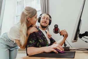 Guy blogger and his beautiful girlfriend at the desk with personal computer photo