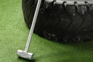 Sledgehammer and tire in the cross training gym photo