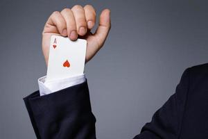 Man is hiding an Ace in the sleeve photo