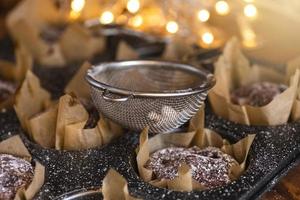 Baking tin with a tasty chocolate muffins photo