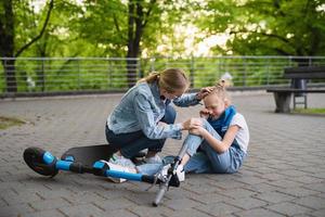 Mother feeling sorry and support her crying daughter after accident e-scooter photo