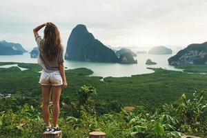 Young woman looking at the beautiful landscape photo