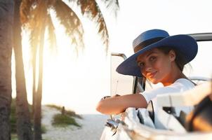 Happy young woman and retro convertible car photo