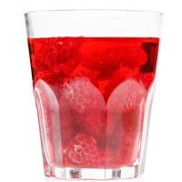 Glass of drink with raspberries on white background photo