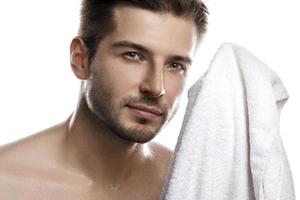 Portrait of young handsome man with wet face photo