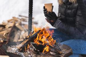 Firewood burning inside the fire-pit during cold winter day photo