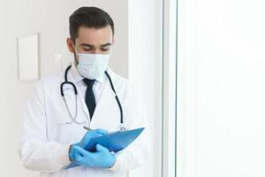 Doctor is holding the clipboard with a documents photo