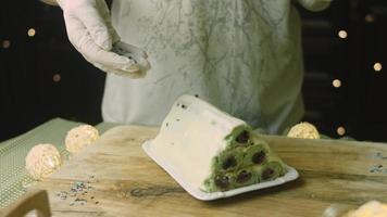 Cake with green dough, sour cherries and sour cream. It also has food ornament and the red star cake video