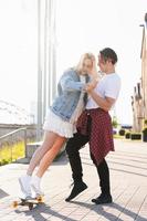 Teenage couple with a longboard during their date in a city photo