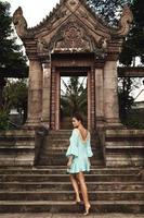 Young woman posing beside ancient Khmer ruins photo