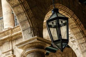 Iron lantern hanging from from an old building photo