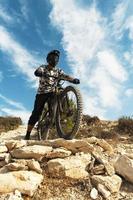 Professional bike rider during downhill ride on his bicycle photo