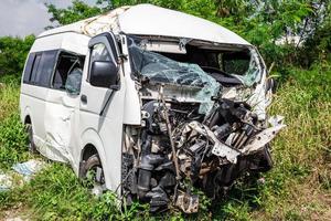 Smashed minivan after serious car accident in the field photo