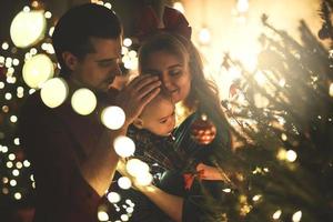 Happy mother and her cute little son are celebrating Christmas or New year. photo