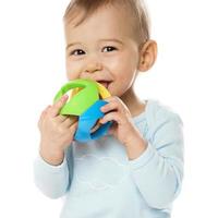 Little boy in romper playing with plastic toy. photo