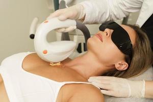 Woman client during IPL treatment in a cosmetology clinic photo