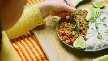 The girl tastes Chili con carne with long rice. Made from turkey with Belgian beer video