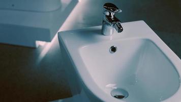 Rotating washbasin. Studio filming. In the background a row of toilets. 4k video