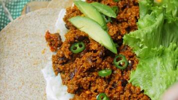 The chef pours veal chorizo over the burrito video