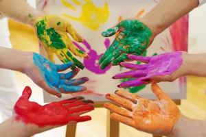 Female palms in colorful rainbow paint colors creating modern artwork to support LGBT community photo