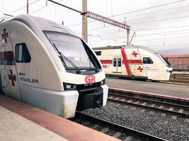 White high-speed fast trains stadler on high-speed rail, train station. Georgia, Batumi, April 18, 2019 photo