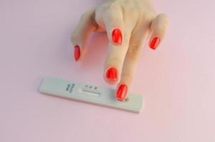 Positive test result by using rapid test for COVID-19, quick fast antibody point of care testing. Lab performing rapid diagnostic test for antibodies to detect presence of antigens COVID-19 disease photo