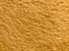texture of beige color. plaster wall in yellow shades. volumetric, embossed wall for art work. unusual warm texture photo