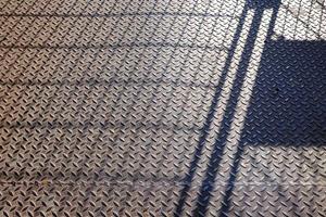 Shadow Fence on Metal Diamond Floor. photo