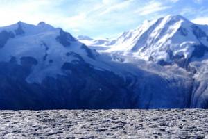 Stone Table in Selective Focus at Surface with Blurred Snow Mountain at Gornergrat Cable Station Background, Suitable for Product Presentation Backdrop, Display, and Mock up. photo