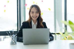 Businesswoman working on a laptop for business information in office. photo