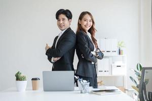 Business people standing with their backs to each other in the office photo