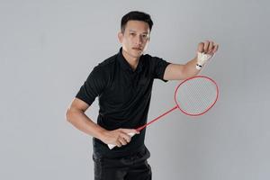 Badminton player wearing sportswear standing holding a racket photo